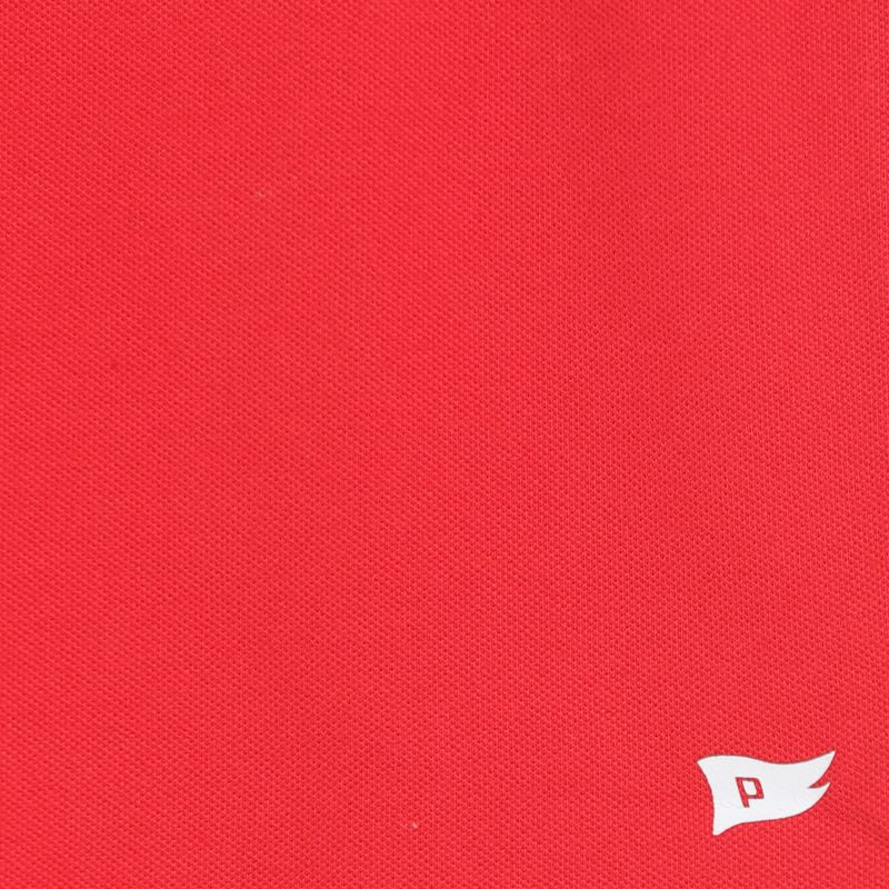 Close-up of red fabric with a small white logo on the bottom right corner.