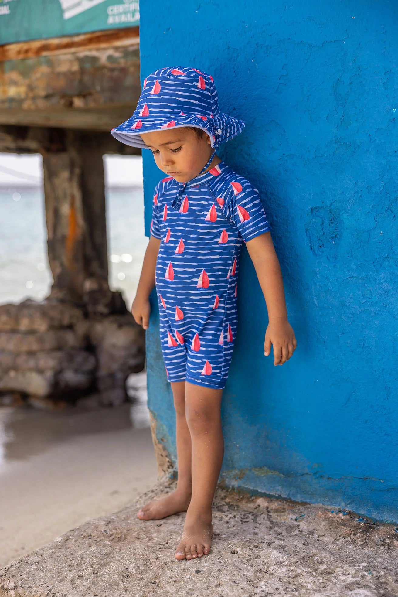 navy and red baby swimsuit with sailboat design