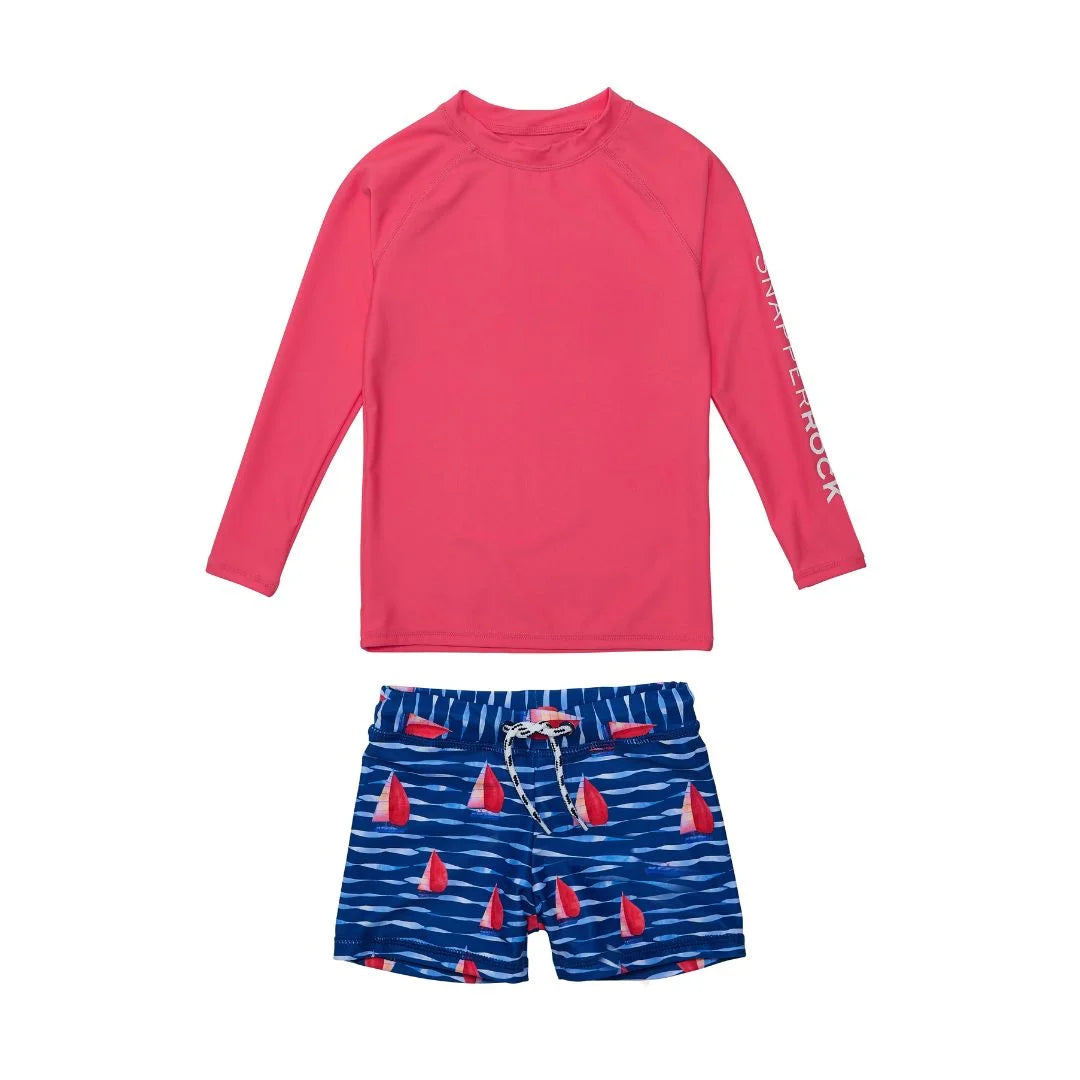 red top with navy swim shorts with sailboats all over