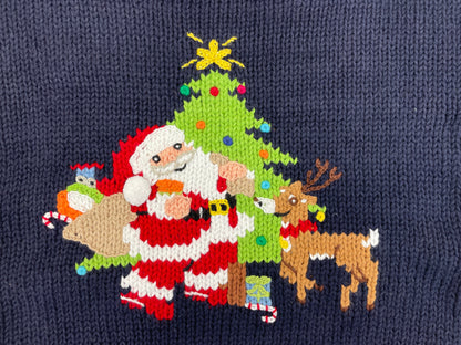 santa_in_front_of_Christmas_tree_with_sack_of_toys_and_reindeer