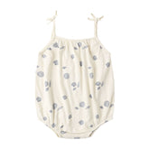 White baby romper with blue shell pattern on a white background