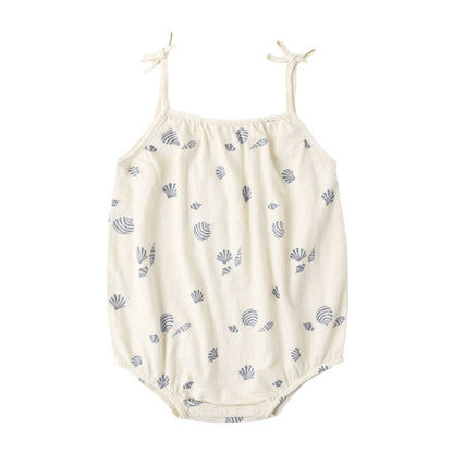 White baby romper with blue shell pattern on a white background