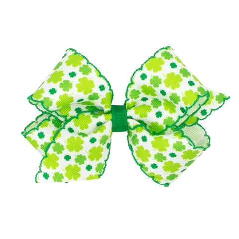 white bow with multi green shamrocks and green embroidred edge