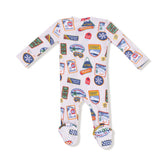 Baby onesie with travel-themed patches on a white background
