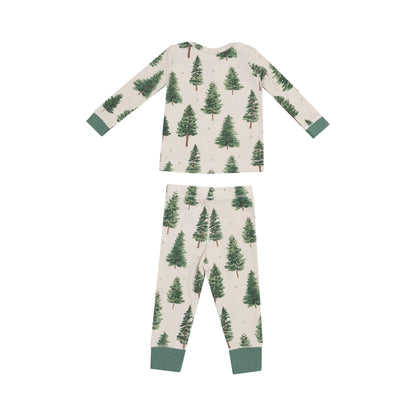 back of tan pajama set with green forest trees all over and green cuffs on wrists and ankles