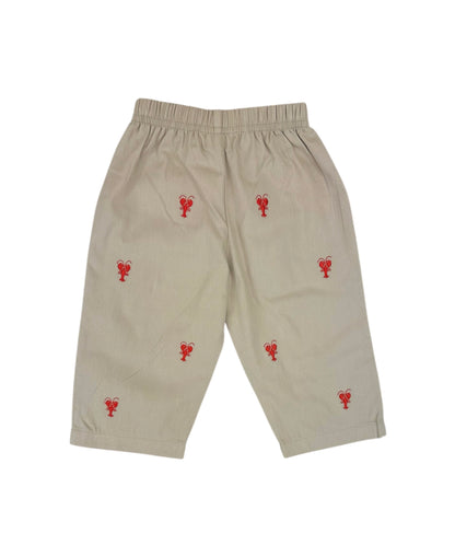 Beige pants with red lobster embroidery on a white background