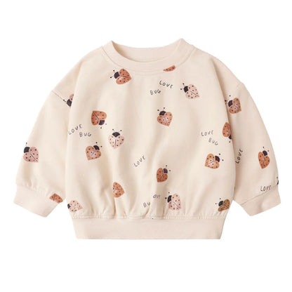 Beige sweatshirt with ladybug patterns on a white background