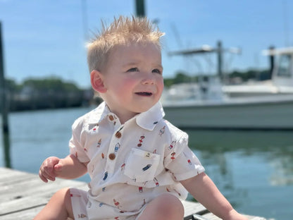 baby wearing buoy romper on dock