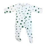 White baby onesie with green shamrock pattern on a white background