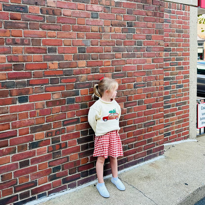 girl wearing christmas sweater