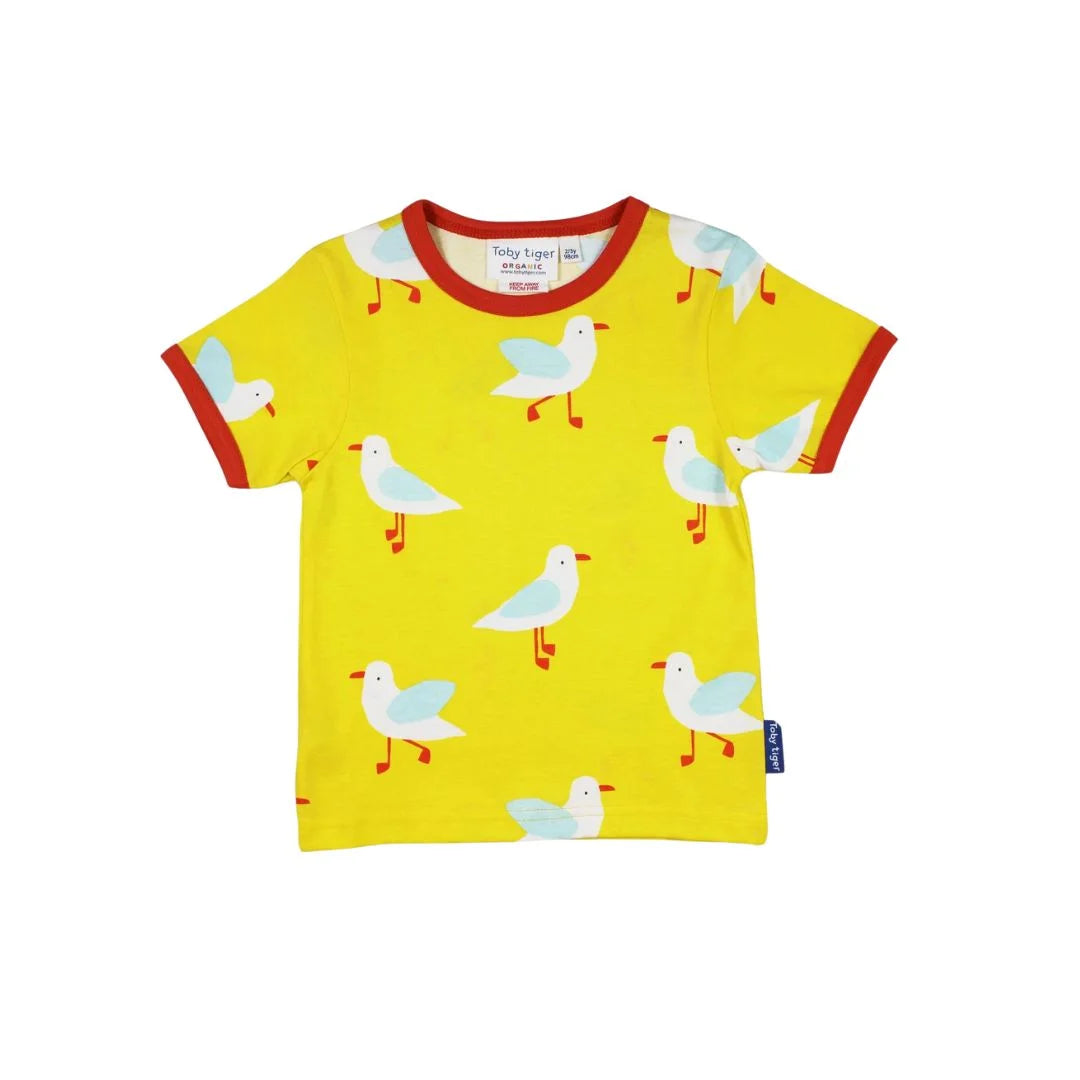 yellow shirt with seagulls all over and orangish reddish trim on sleeves and neckline