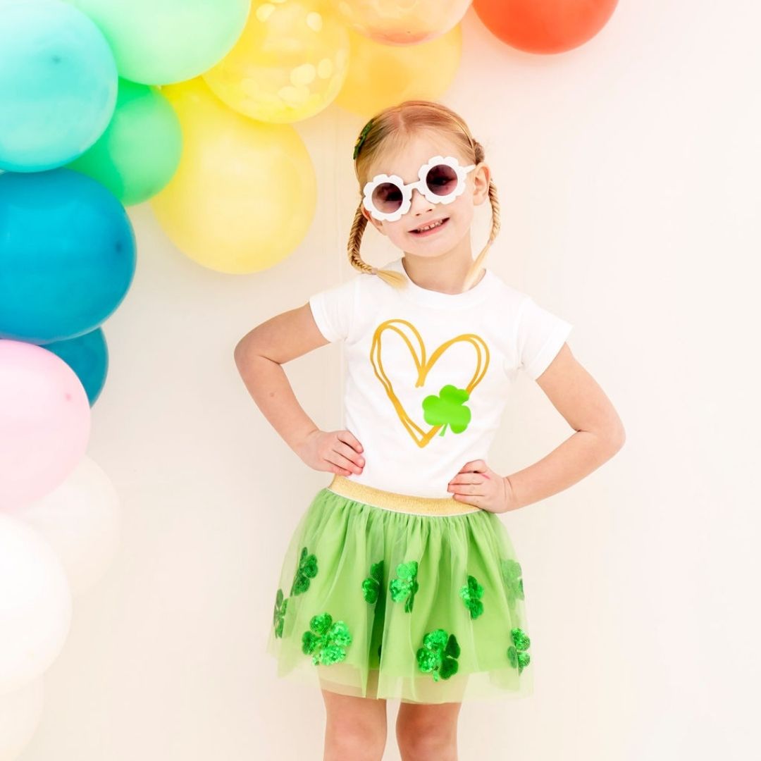 little girl wearing the tutu with a white tee and sunglasses