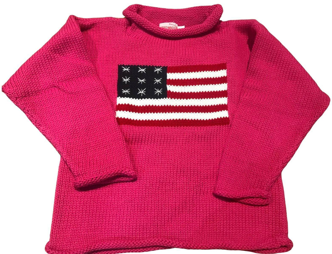 hot pink roll neck sweater with American flag knitted on front center of sweater