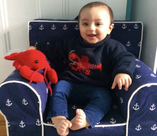 baby wearing Navy Lobster Roll Neck Sweater with jeans and had lobster plush