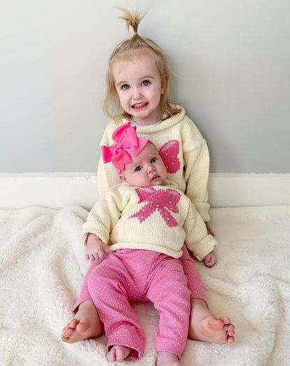 toddler and baby wearing leggings and bow sweater