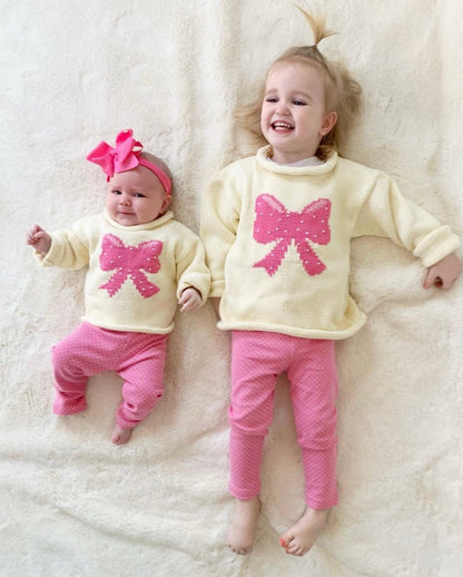 toddler and baby wearing leggings and bow sweater