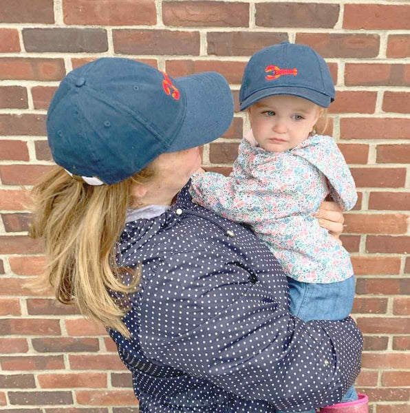 mom and daughter wearing matching navy lobster hats