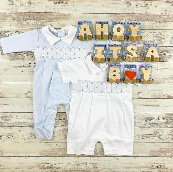 shows two baby outfits with name trains spelling Ahoy Its A Boy