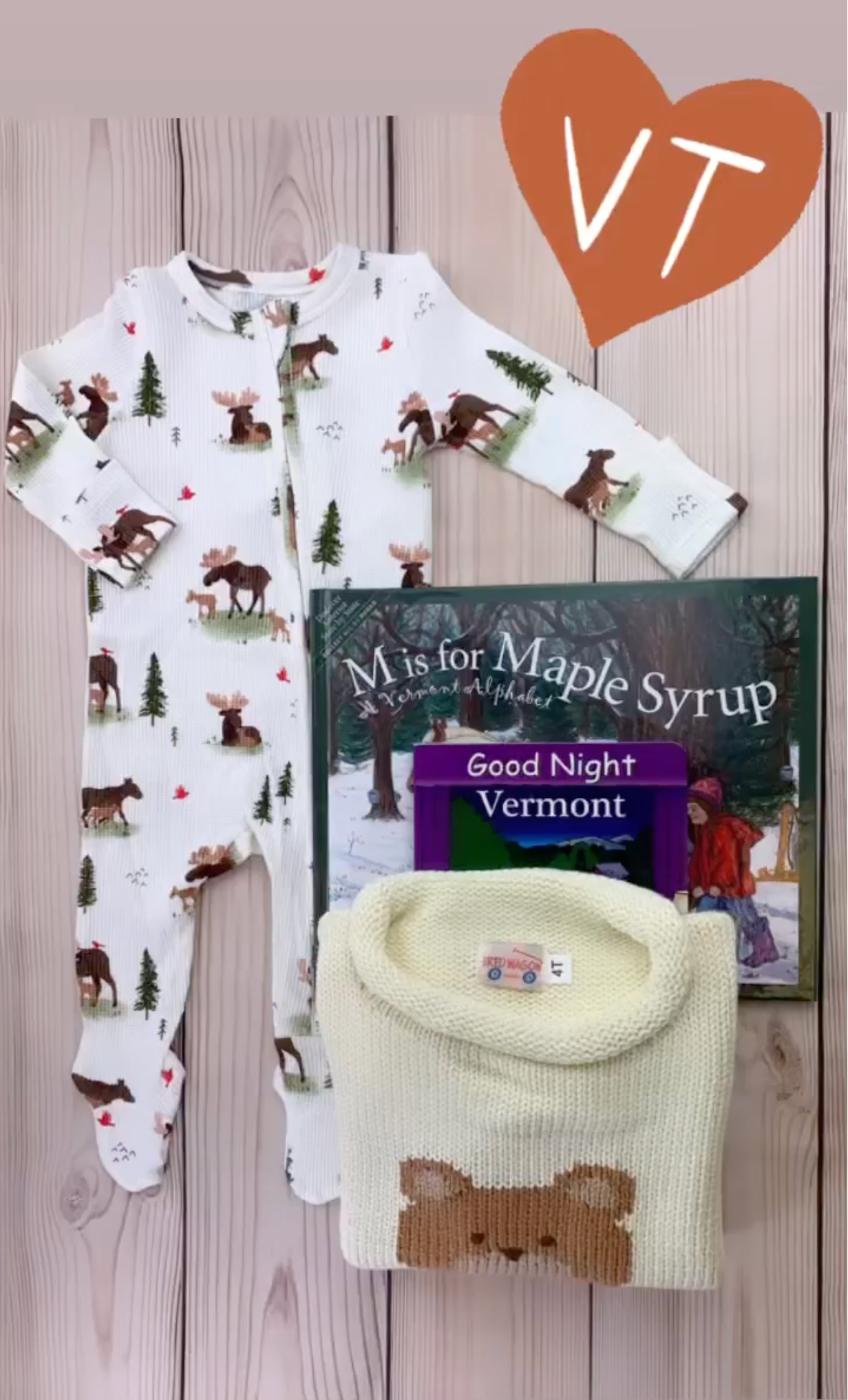 shows moose footie and bear sweater with vermont books