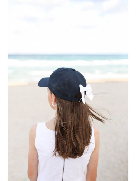girl wearing hat at beach