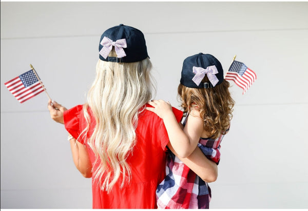 women and girl wearing hats with American flags