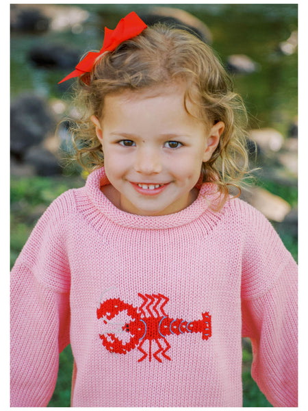 girl wearing pink lobster sweater