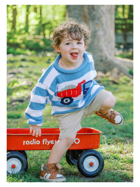 boy wearing striped dump truck sweater