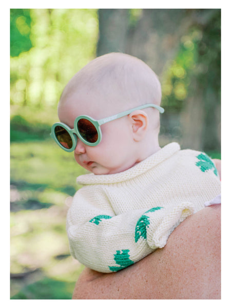 baby wearing sweater and green sunglasses