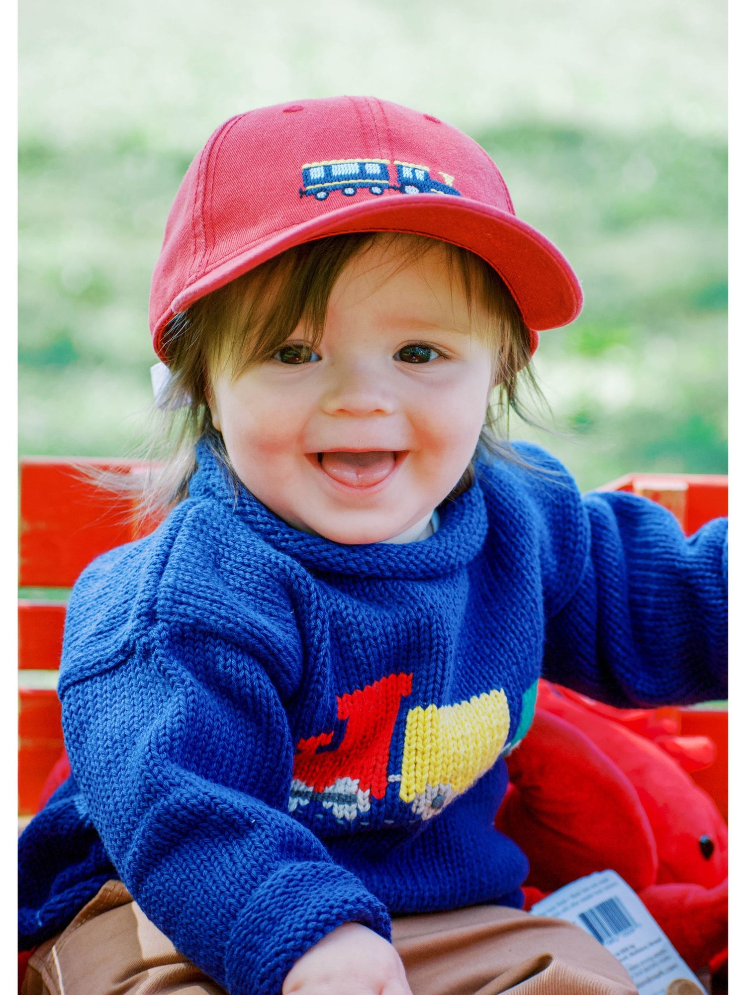 baby wearing train sweater and train hat