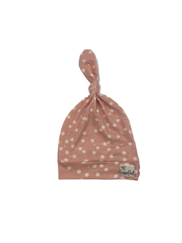 pink knotted hat with white polka dots