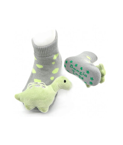 gray socks with light green dinosaur plush rattle on toes