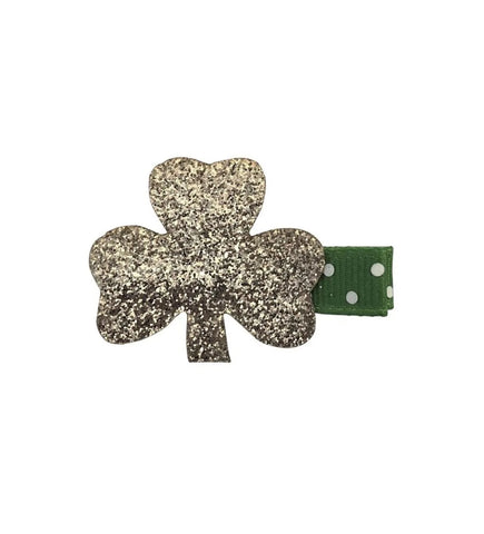 gold glitter shamrock on a green clip with white polka dots