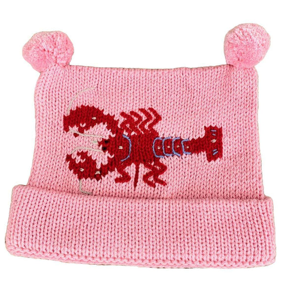pink knit hat with red horizontal lobster in center with two pink poms at top, bottom of hat is rolled up once