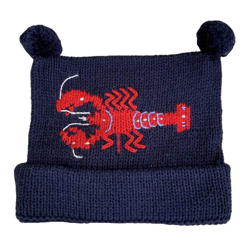 navy knit hat with red horizontal in the center with two navy poms at top, bottom of hat is rolled up once