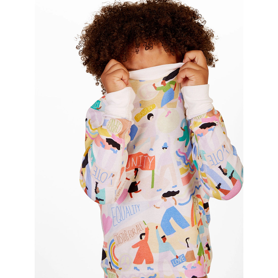 child covering their face in pajamas