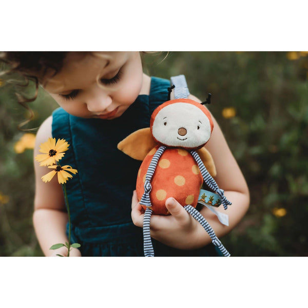 child holding girlbug plush
