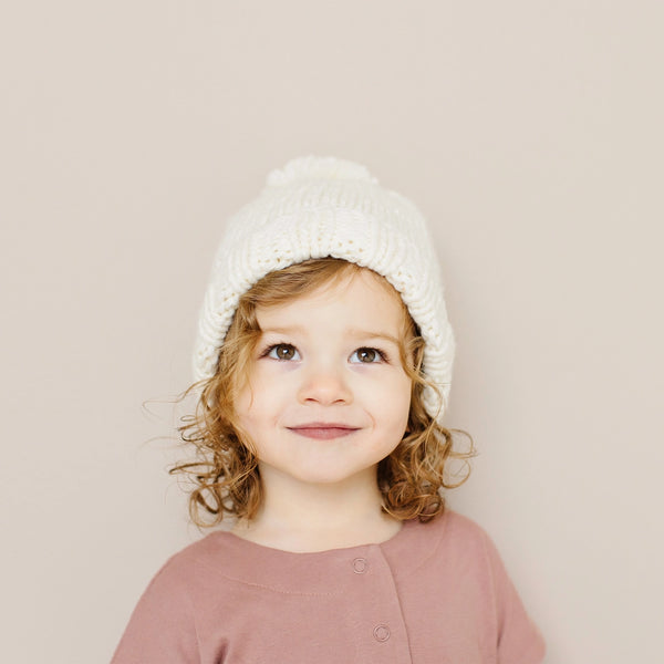 little girl wearing hat