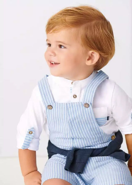 baby wearing overalls with white long sleeve shirt