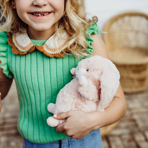 girl holding bunny plush