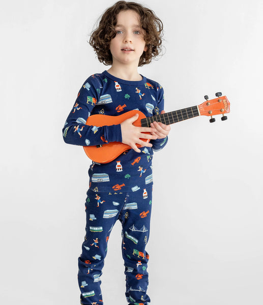 little boy wearing pajamas and holding ukulele