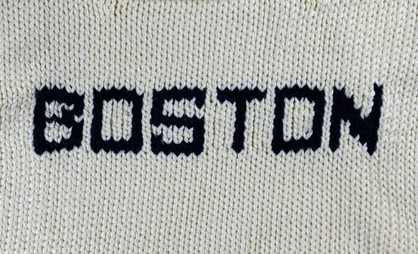 close up of BOSTON lettering in navy blue knit