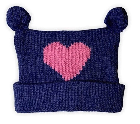 navy knit hat with pink heart in center, two navy poms at top with bottom of hat rolled up once