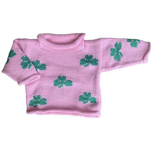 pink roll neck sweater with green shamrocks knitted all over