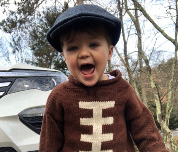 little boy wearing football sweater
