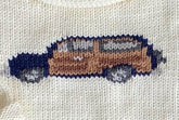 close up of knitted tan station wagon car outlined in navy