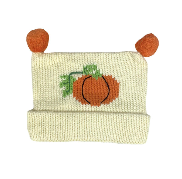 ivory hat with orange pumpkin in center with black detailing and green stem, 2 orange poms on top, hat is rolled up once