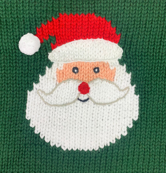 close up of santa face, white beard, red nose, peach face and red and white hat