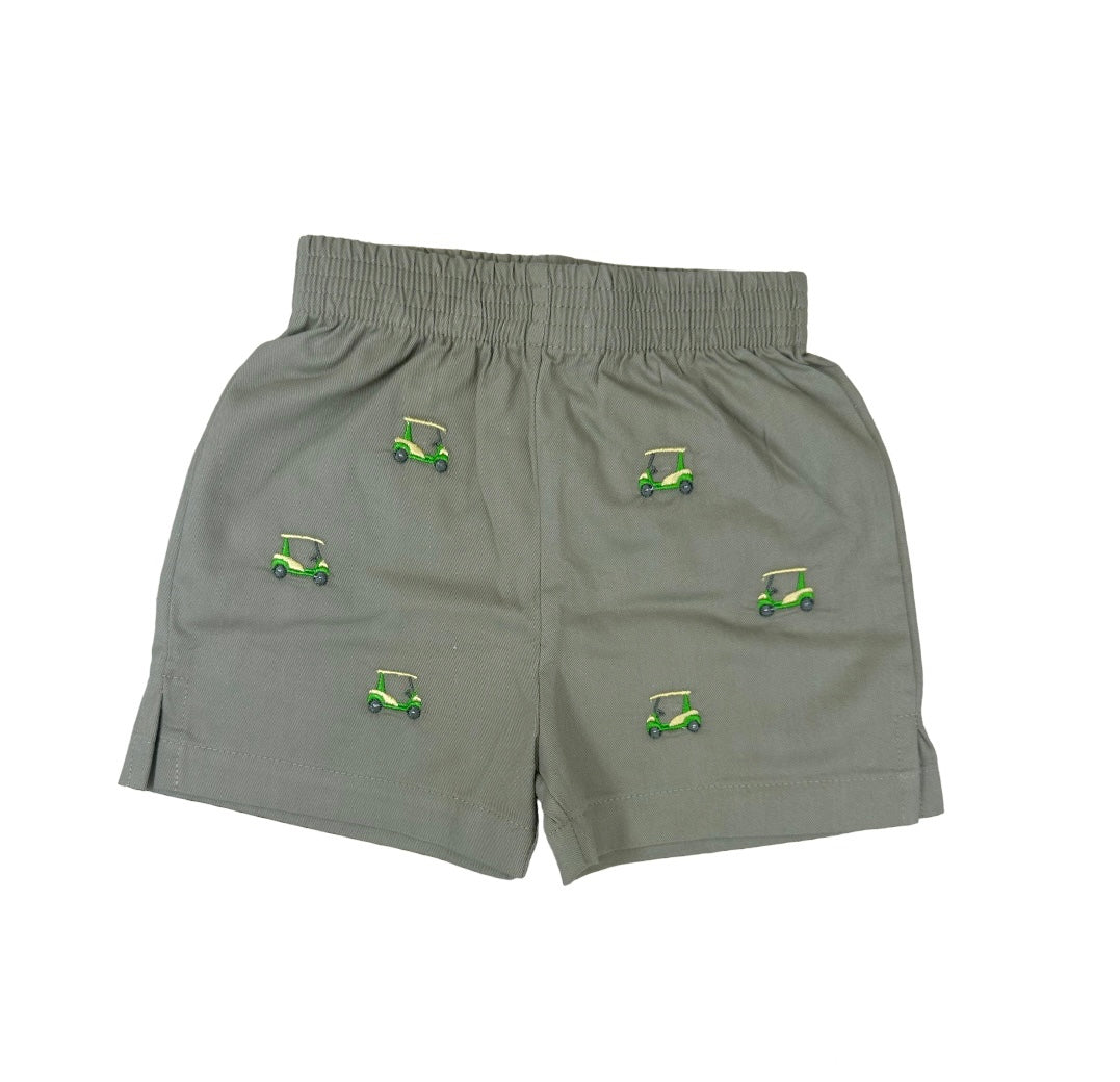tan shorts with embroidered yellow and green golf carts all over