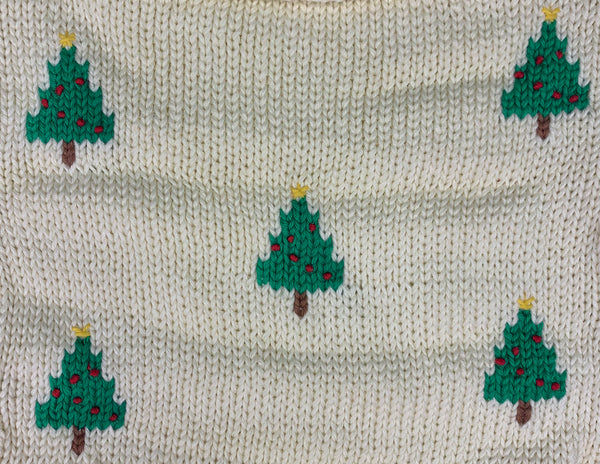 close up of Christmas trees, green with red ornaments and yellow star at top