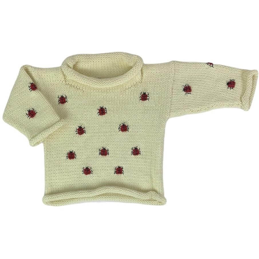 ivory roll neck sweater with small red and black lady bugs embroidered all over
